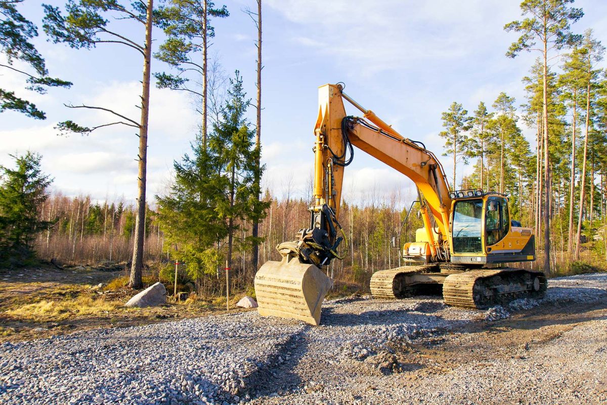 Yellow excavator building a road deep in the forest. Rusko, Finl
