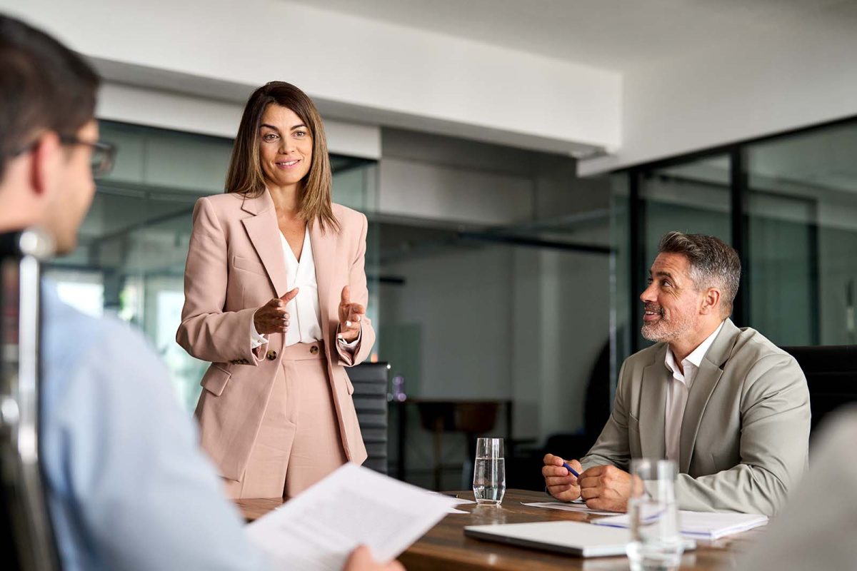 Busy mature professional board executive colleagues successful business team people collaborating having corporate teamwork discussion together at group office conference meeting boardroom table.